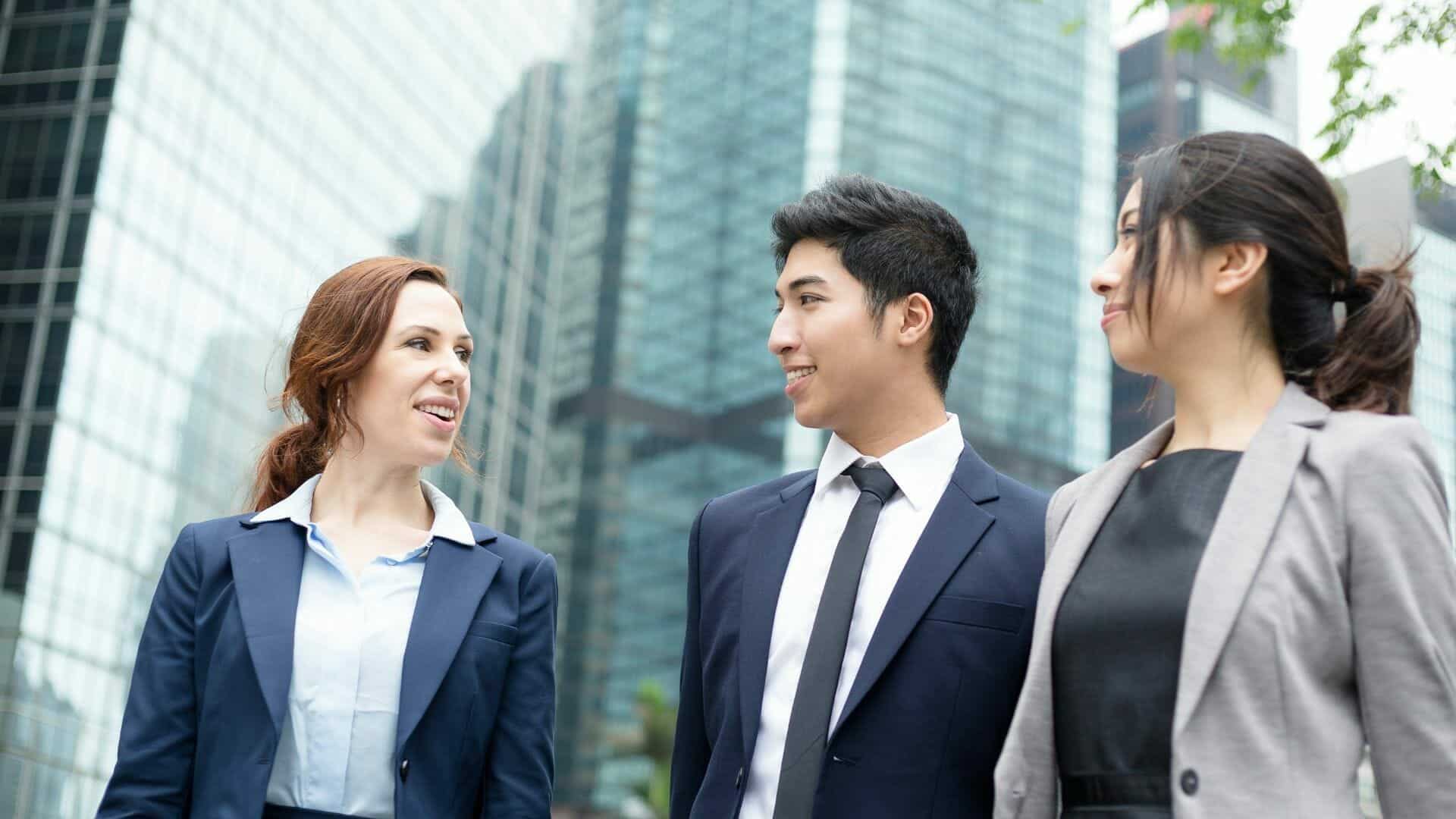 3 team members outside, smiling